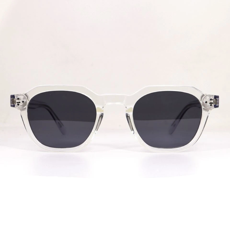 Transparent acetate sunglasses front view showing rim structure and dark polarized lenses Transparent acetate sunglasses front view showing rim structure and dark polarized lenses